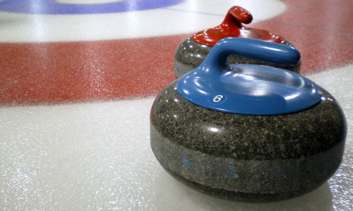 Curling_stones_on_rink_with_visible_pebble