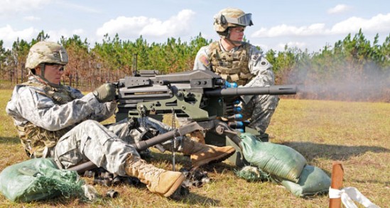 Spc. Patrick L. Noel of Cincinnati, Ohio, continues to fire as his assistant gunner, Spc. Philip J. Gavin of Newark, Ohio, Personal Security Detail Soldiers assigned to Headquarters and Headquarters Company, 37th Infantry Brigade Combat Team, feeds ammunition to their MK19 machine gun during qualification at Camp Shelby Joint Forces Training Center, Miss., Nov. 16, 2011. The 37th IBCT is deploying to Afghanistan in support of Operation Enduring Freedom. (37th IBCT photo by Sgt. Kimberly Lamb) (Released)